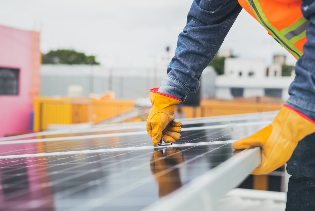 worker installing solar panels