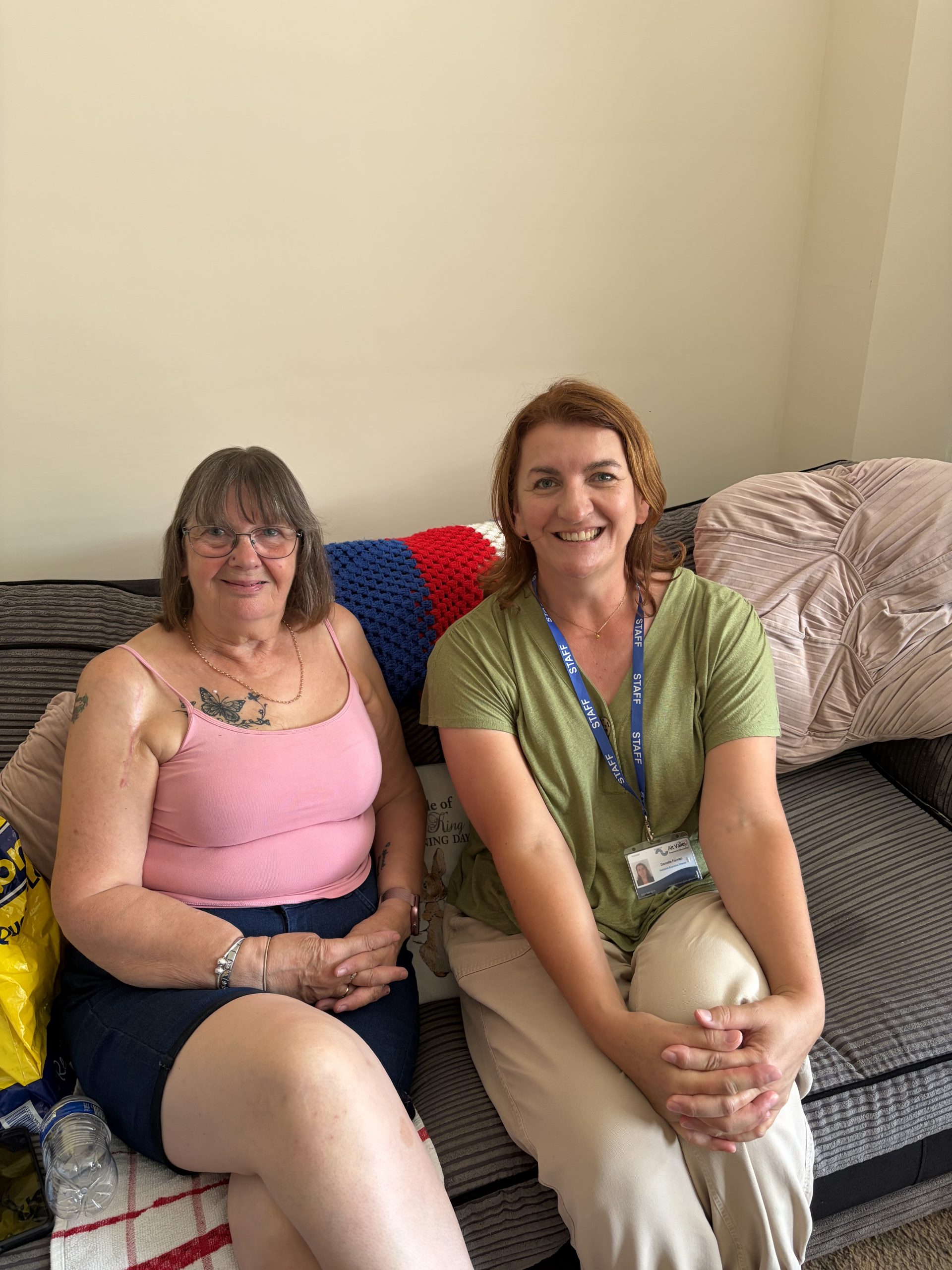 Two women sat next to each other. One is Danielle from Alt Valley Community Trust, the other is a housing tenant.